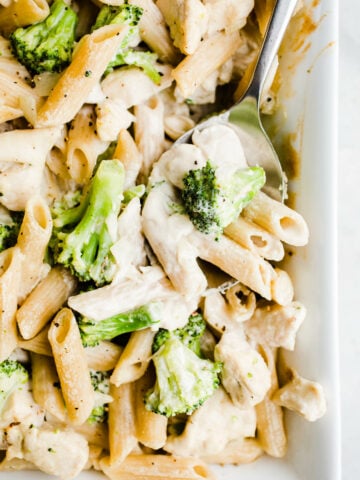 A creamy pasta baked in a white casserole dish.