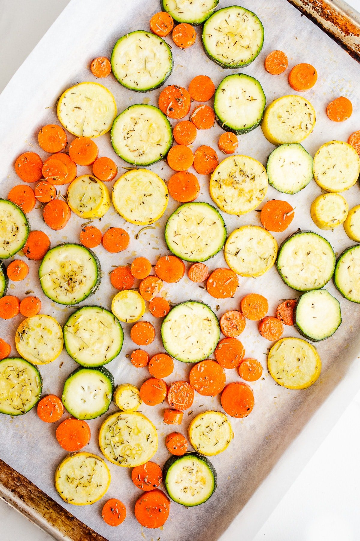 Season veggies in a layer on sheet pan.